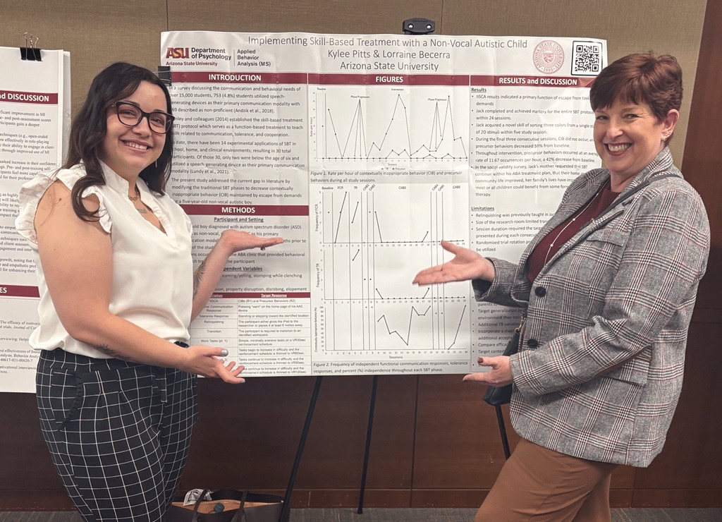 Kylee Pitt standing in front of her poster presentation.